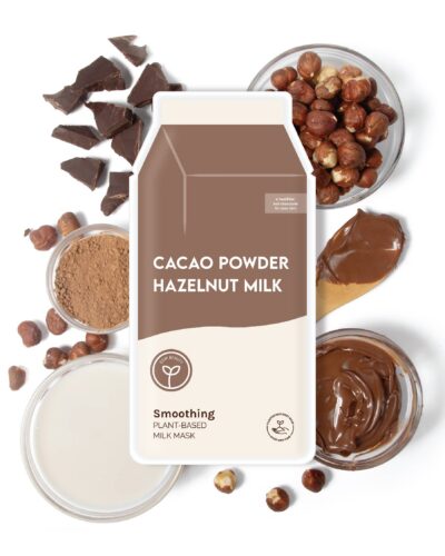 ESW Beauty Cacao Powder Hazelnut Milk Smoothing Plant-Based Milk Mask surrounded by cacao powder, hazelnuts, chocolate pieces, hazelnut spread, and milk.