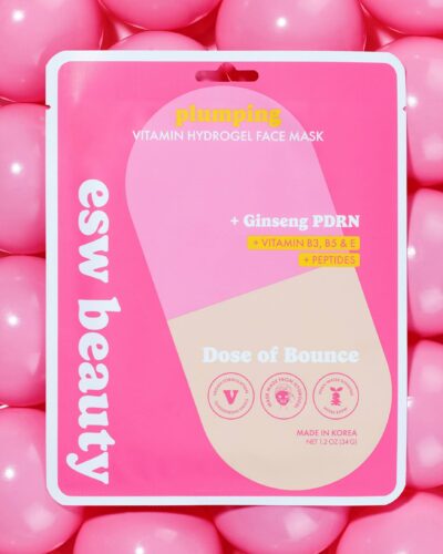 ESW Beauty Dose of Bounce Plumping Vitamin Hydrogel Face Mask package displayed on a bright pink background with glossy pink capsule-like shapes.