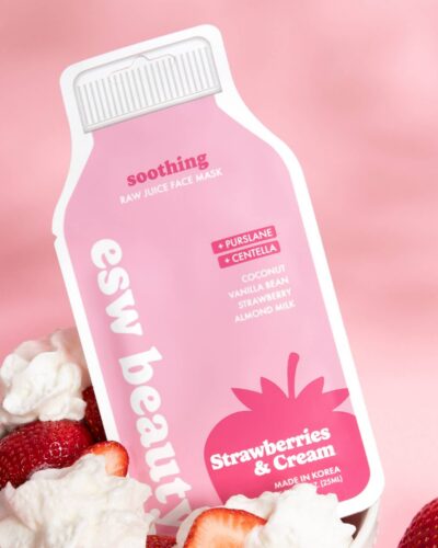 ESW Beauty Strawberries & Cream Soothing Raw Juice Sheet Mask package styled with fresh strawberries and whipped cream on a pink background.