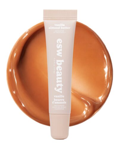 Vanilla Almond Butter Smoothie Lip Treatment tube displayed over a glossy caramel-brown swatch on a white background.