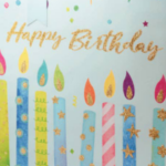 closeup image of happy birthday text and candles on gift bag design