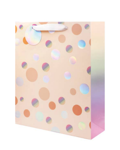 Large peach gift bag with iridescent polka dots and white ribbon handles